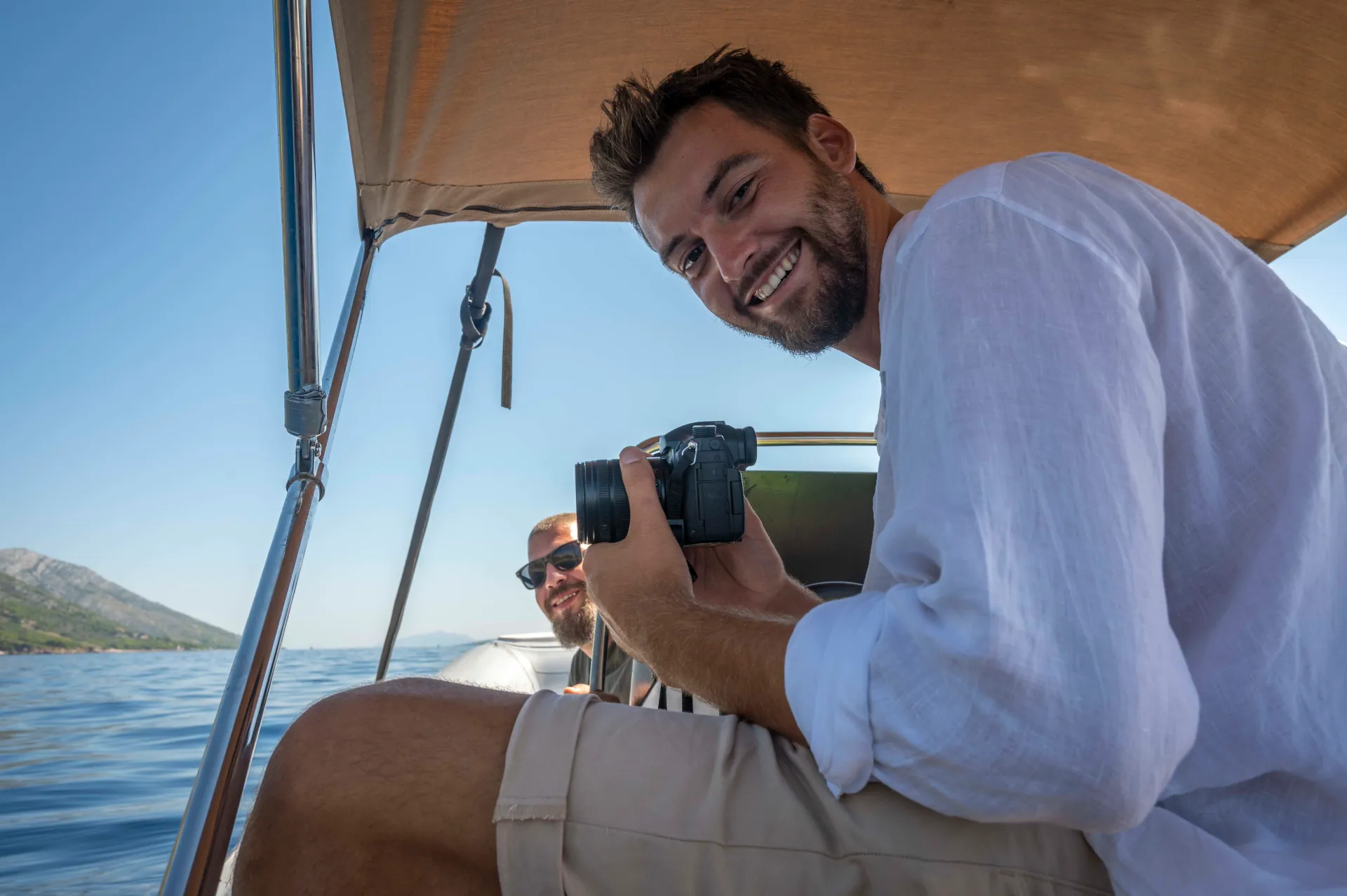 Antonio on the boat, holding a camera