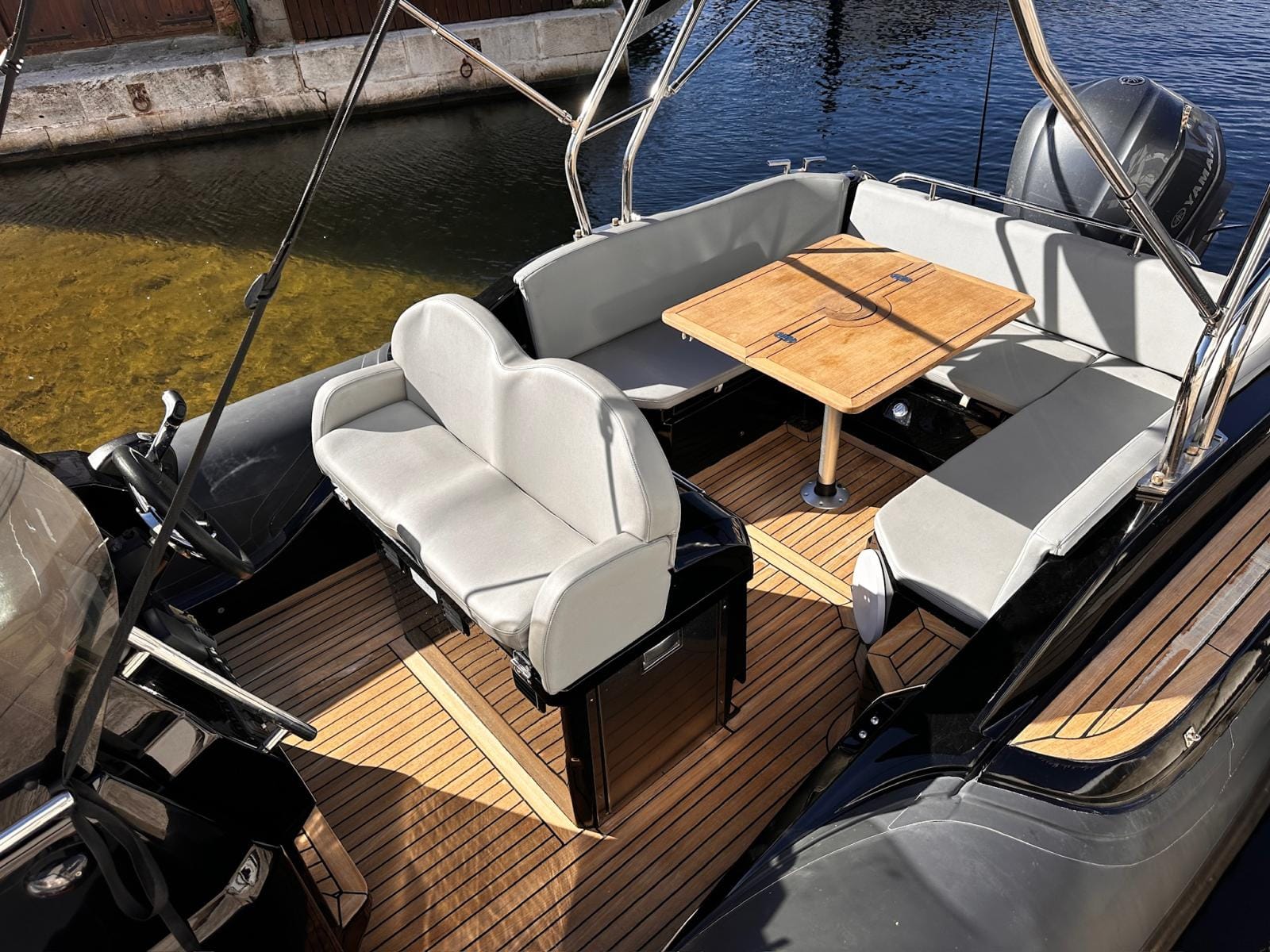 Joker Clubman 28 — teak deck, lounge seating and table
